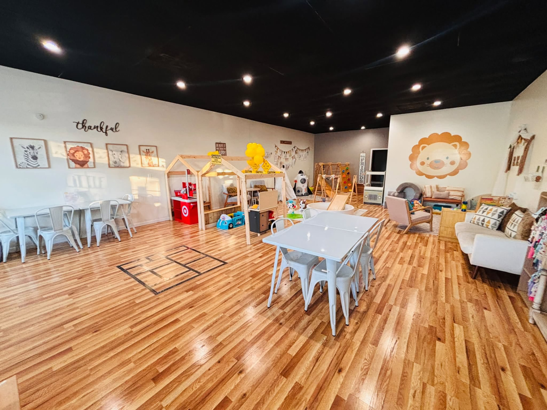 Little Lions Den's main room with play areas and tables for private parties
